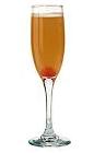 The Mimosa drink is made from orange curacao, orange juice and champagne, and served in a champagne flute.
